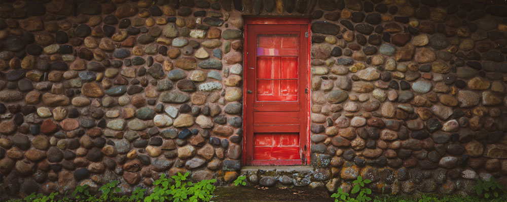 Red door to the lakeside getaway Stone House cabin on Lake Mille Lacs